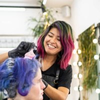 hairdresser dyeing client's hair at hair salon - hairstyle stock pictures, royalty-free photos & images
