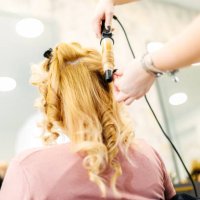 hairstylist using curling iron in salon - hairstyle stock pictures, royalty-free photos & images