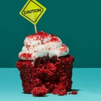 half eaten cupcake with caution sign - food stock pictures, royalty-free photos & images