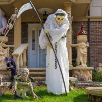 halloween decoration with grim reaper holding scythe in front of a house in brooklyn, new york, usa. - garden decoration stock pictures, royalty-free photos & images