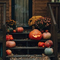 halloween jack-o'-lantern and pumpkins decorating a wooden porch - garden decoration stock pictures, royalty-free photos & images
