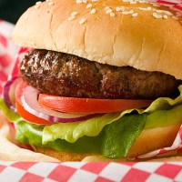 hamburger with lettuce, tomato, red onion and french fries - junk food stock pictures, royalty-free photos & images