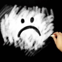 hand drawing sad face with chalk in black board - junk food stock pictures, royalty-free photos & images