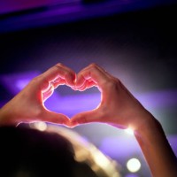 hand heart shape in the purple lighting of the concert hall. - concert stock pictures, royalty-free photos & images