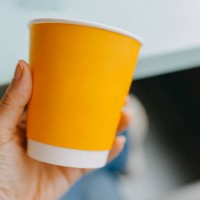 hand holding a paper cup - junk food stock pictures, royalty-free photos & images
