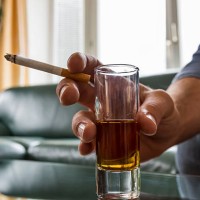 hand holding cigarette and shot glass - junk food stock pictures, royalty-free photos & images
