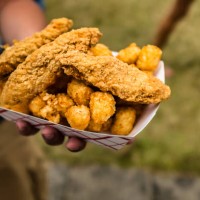 hand holding container of fried chicken and potatoes - junk food stock pictures, royalty-free photos & images