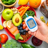 hand holding glucometer on healthy food background - food stock pictures, royalty-free photos & images