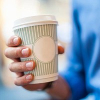 hand holding takeaway coffee - junk food stock pictures, royalty-free photos & images