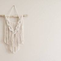 hand made natural cotton macrame decoration hanging on white wall. wall panel in boho style made of cotton threads in natural white color using the macrame technique for home decor and wedding decoration. - home decoration st