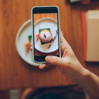 hand of an anonymous young woman taking a snapshot of her delicious looking pumpkin spice late in order to post it to social media - food stock pictures, royalty-free photos & images