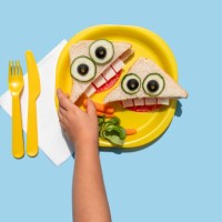hand of baby girl picking up funny looking sandwich withanthropomorphic face - food stock pictures, royalty-free photos & images