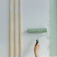 hand of woman painting with paint roller on wall at home - home decoration stock pictures, royalty-free photos & images