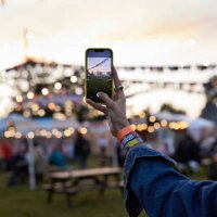 hand of woman photographing bunting through phone - concert stock pictures, royalty-free photos & images