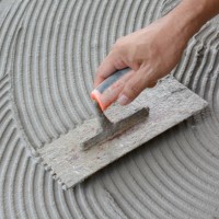 hand on be bound with cement , do cement work, apply cement (over a surface) - home decoration stock pictures, royalty-free photos & images