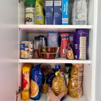 hand reaching for the pasta in the kitchen cabinet - food stock pictures, royalty-free photos & images