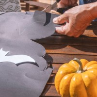 hands cutting black craft paper bats for halloween - garden decoration stock pictures, royalty-free photos & images