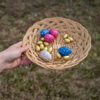 hands holding basket with chocolate eggs - garden decoration stock pictures, royalty-free photos & images