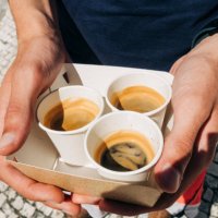 hands holding coffee cups: high angle view of young adult holding disposable coffee cups - junk food stock pictures, royalty-free photos & images