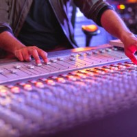 hands of a male audio engineer adjusting the sound on a audio mixer in a recording studio - concert stock pictures, royalty-free photos & images