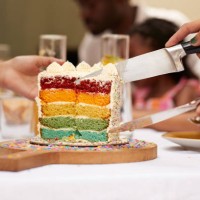 hands of guests with knife taking cake slice - garden decoration stockfoto's en -beelden