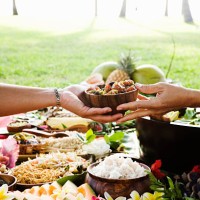 hands passing bowl at hawaiian picnic - food stock pictures, royalty-free photos & images