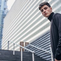 handsome man in black clothing standing on stairs - fashion stock pictures, royalty-free photos & images
