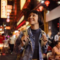 happy asian tourist enjoying on the city street at night. - travel stock pictures, royalty-free photos & images