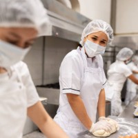 happy baker working at a food processing plant kneading the dough - food stock pictures, royalty-free photos & images