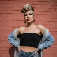 happy beautiful fashion hipster young woman smiling while posing in front of red brick wall - hairstyle stock pictures, royalty-free photos & images