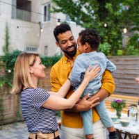 happy biracial family with small son during family dinner outdoors in garden. - garden decoration photos et images de collection