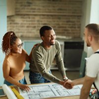 happy black couple shaking hands with manual worker in moving house. - home decoration stock pictures, royalty-free photos & images