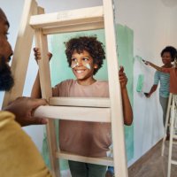 happy black father and son talking through ladders during home renovation process. - home decoration stock pictures, royalty-free photos & images