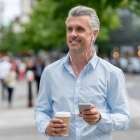 happy business man listening to music outdoors - junk food stock pictures, royalty-free photos & images