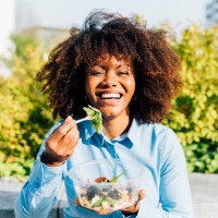 happy businesswoman eating salad on sunny day - food stock pictures, royalty-free photos & images