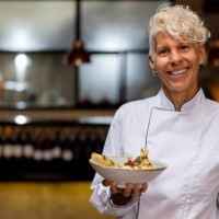 happy chef holding a plate at a fine dining restaurant - food stock pictures, royalty-free photos & images