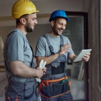 happy construction workers using touchpad at renovating house. - home decoration stock pictures, royalty-free photos & images