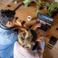happy couple at home booking a trip online - travel stock pictures, royalty-free photos & images