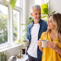 happy couple at home drinking a cup of coffee - coffee stock pictures, royalty-free photos & images
