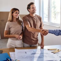 happy couple came to a successful deal with interior designer in the apartment. - home decoration stock pictures, royalty-free photos & images