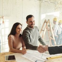 happy couple came to an agreement with agent at construction site. - home decoration stock pictures, royalty-free photos & images