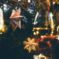 happy couple celebrate christmas with champagne against the backdrop of a christmas paper star in the backyard. - garden decoration stock pictures, royalty-free photos & images