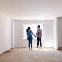 happy couple holding hands at a construction site while building their house - home decoration stock pictures, royalty-free photos & images