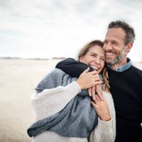 happy couple hugging on the beach - travel stock pictures, royalty-free photos & images