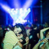 happy couple in love having fun during music festival by night. - concert stock pictures, royalty-free photos & images