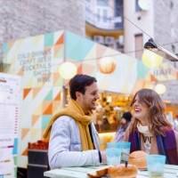 happy couple laughing during dinner near food truck - junk food stock pictures, royalty-free photos & images