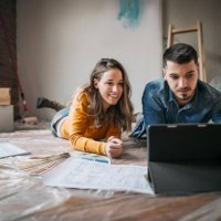 happy couple lying down in new home - home decoration stock pictures, royalty-free photos & images