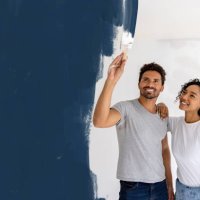 happy couple painting their house - home decoration stock pictures, royalty-free photos & images