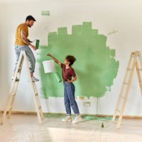 happy couple painting their new apartment. - home decoration stock pictures, royalty-free photos & images