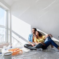 happy couple sitting on floor at new home - home decoration stock pictures, royalty-free photos & images